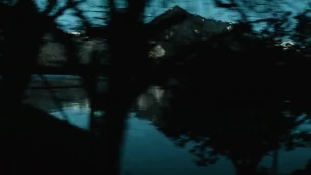 Revealing Mountains Lake Moving Train Bare Trees Foreground Switzerland Scenery — Αρχείο Βίντεο