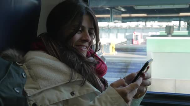 Commuter Woman Engaged Smartphone Train Window Smiling Female Passenger Holding — Vídeo de stock