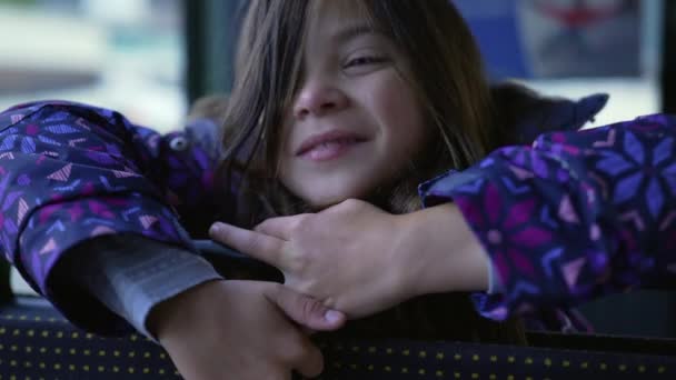 Closeup Pensive Happy Little Girl Face Leaning Bus Seat Smiling — Stockvideo