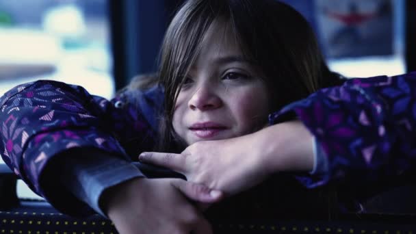 Introspective Child Leaning Bus Seat Backward Thoughtful Pensive Expression Closeup — Vídeo de Stock