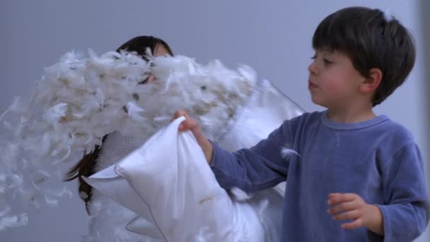 Small Brother Sister Having Pillow Fight Feathers Flying Everywhere Captured — Stock Video