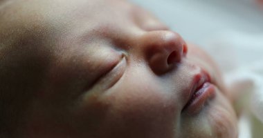 Close-up of newborn baby face portrait in macro