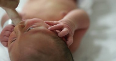 Calming newborn baby by suckling finger feeding