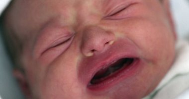 Close-up of newborn baby infant crying, first day of life