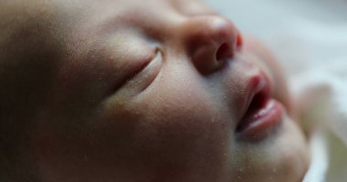 Close-up of newborn baby face portrait in macro