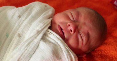 Newborn baby infant wrapped with towel