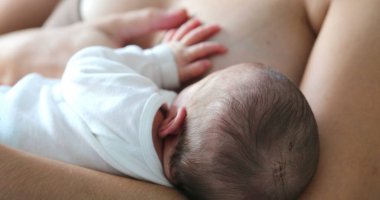 Mom breastfeeding infant newborn baby
