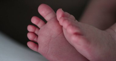 Newborn baby feet close-up. Toes of infant macro