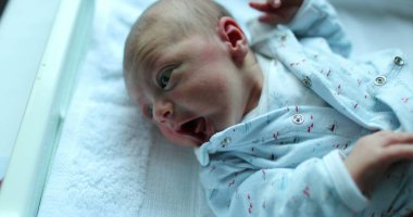 Cute newborn baby infant awake in first week of life