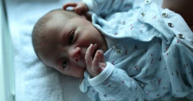 Cute newborn baby infant awake in first week of life