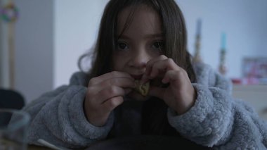 Young Child Having Pancake for Breakfast in Cozy Home Setting, small girl enjoying food snack