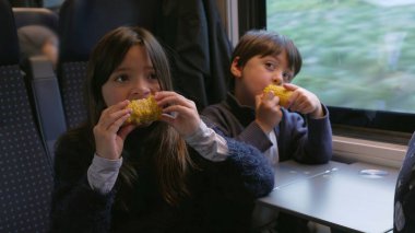 Siblings Snacking Corn in Moving Train - Brother and Sister Enjoying Healthy Food