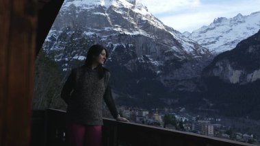 Absorbed by Nature - Woman Contemplating Swiss Alps in Winter