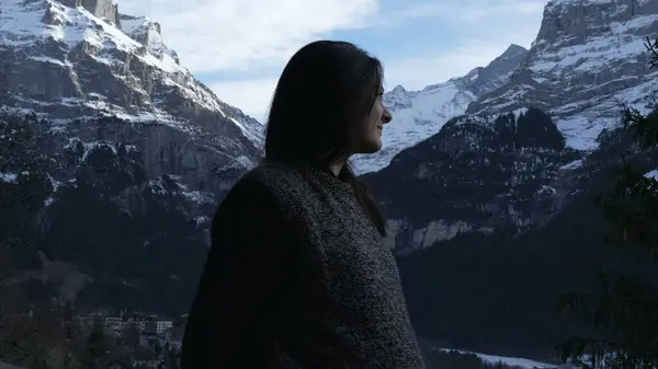 Profile Face of Contemplative Woman Enjoying Mountain View in Winter