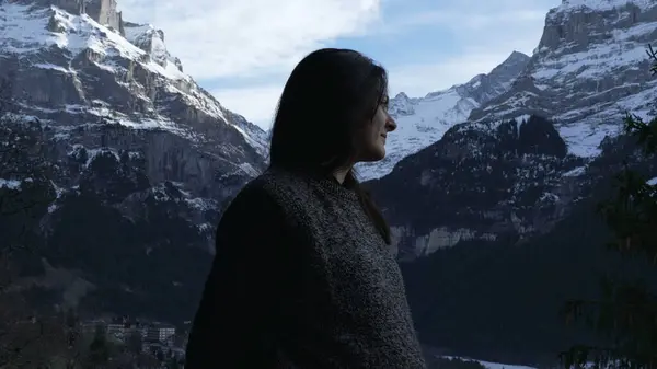 Profile Face of Contemplative Woman Enjoying Mountain View in Winter