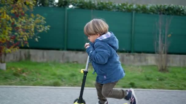 Aktywny Trzyletni Chłopiec Cieszący Się Jazdą Trójkołowym Skuterze Zewnątrz — Wideo stockowe