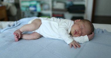 Newborn baby sleeping in bed, cute infant asleep