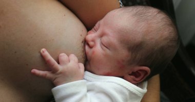 Newborn baby infant breastfeeding suckling feeding