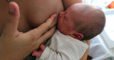 Mother breastfeeding newborn baby infant
