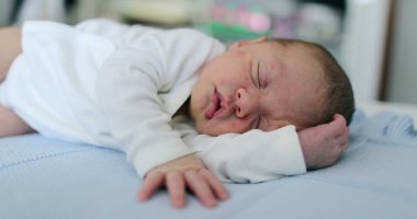 Newborn baby infant sleeping in bed