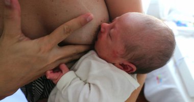 Mother breastfeeding newborn baby infant