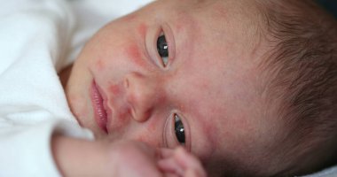Newborn baby face with tired look