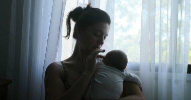 Mother talking to newborn baby showing love and affection