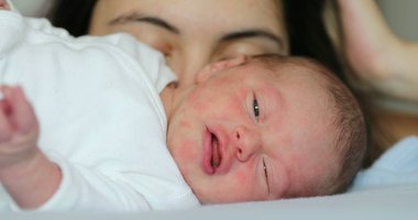 Newborn baby infant sleeping in bed