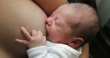 Newborn baby infant breastfeeding suckling feeding