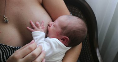 Mother breastfeeding newborn baby infant