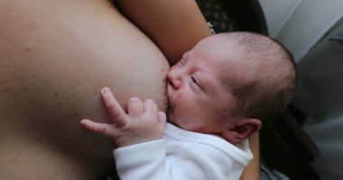 Mother breastfeeding her newborn baby infant son