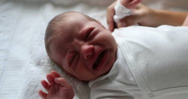 Crying newborn baby infant complaining first days of life
