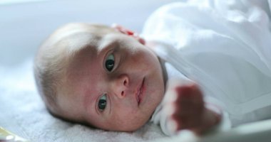 Newborn baby in first month of life observing the world
