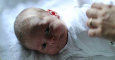 Newborn baby in first month of life observing the world
