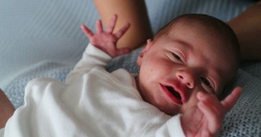 Mother calming and consoling crying newborn baby