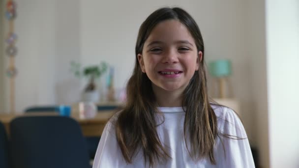 Одна Счастливая Маленькая Девочка Улыбается Смеется Над Камерой Стоящей Помещении — стоковое видео