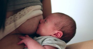 Newborn baby infant breastfeeding at night first week of life