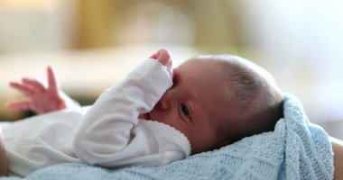 Adorable newborn baby infant waking up from nap