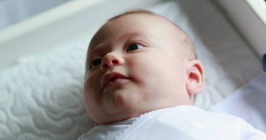 Adorable cute baby newborn looking and observing