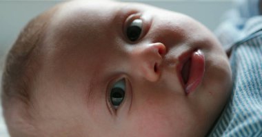 Baby newborn closeup face looking to camera