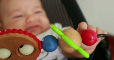 Baby hand playing with toy
