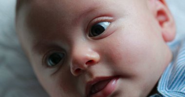 Closeup of baby newborn infant face macro portrait