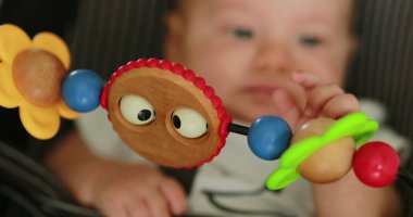 Closeup of baby toy infant spinning toy in foreground