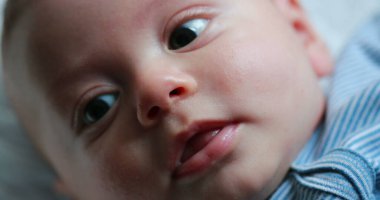Closeup of baby newborn infant face macro portrait