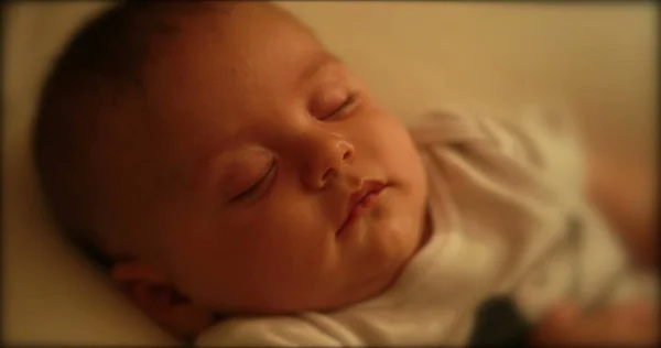 Closeup of serene baby asleep at night sleeping eyes closed