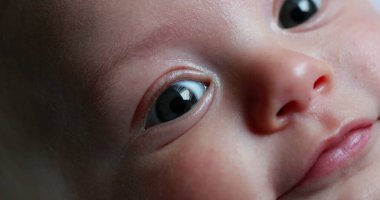 Macro closeup of baby newborn portrait face expression detail