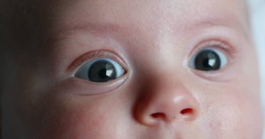 Macro closeup of baby newborn portrait face expression detail