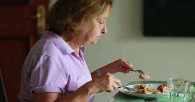 Older woman eating lunch candid authentic