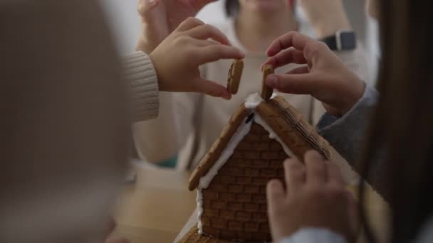 Close Children Hands Adding Chimney Top Gingerbread Home Mother Help — Stock Video