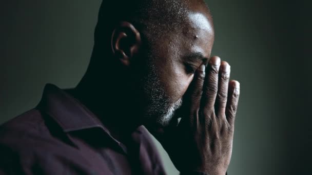 One Religious Black Senior Man Contemplative Prayer Home Dimly Lit — Stock Video